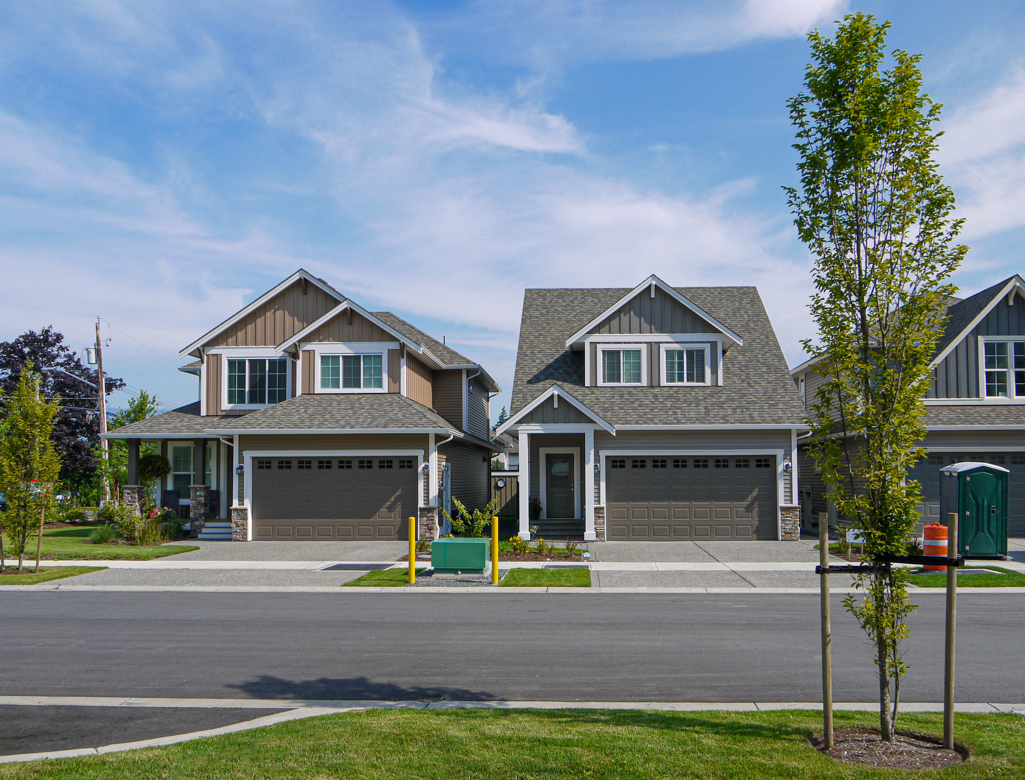 Brand new residential houses with concrete driveway and asphalt road in front
